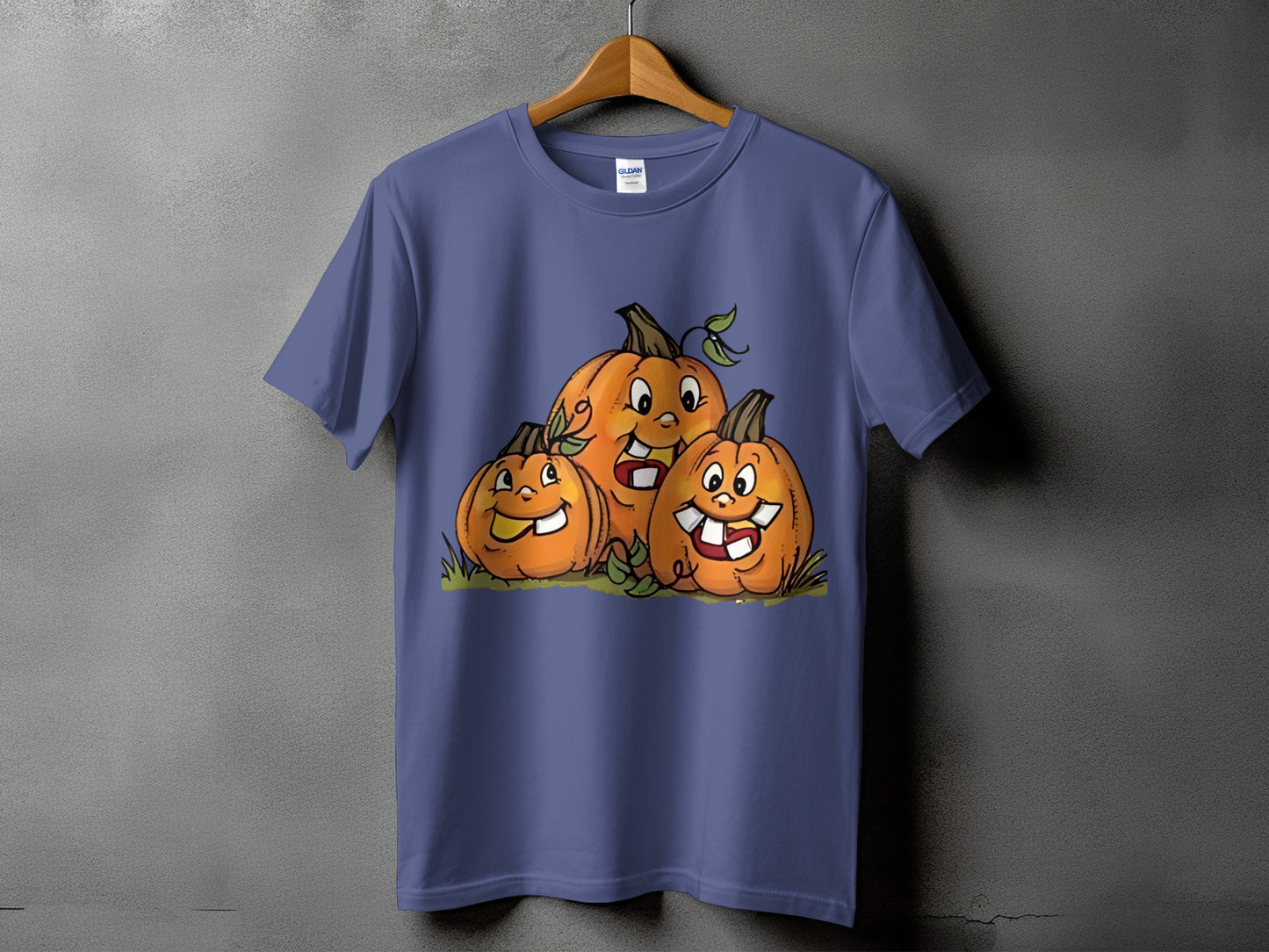 Three cartoon pumpkins with smiling faces on a purple t-shirt.