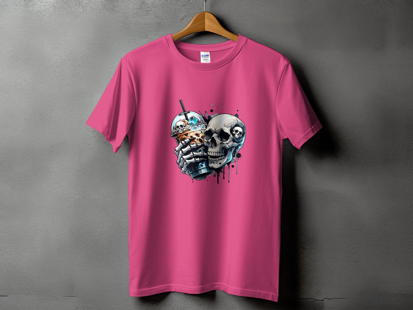 Pink t-shirt with a graphic of a skeleton holding a coffee drink and a skull.