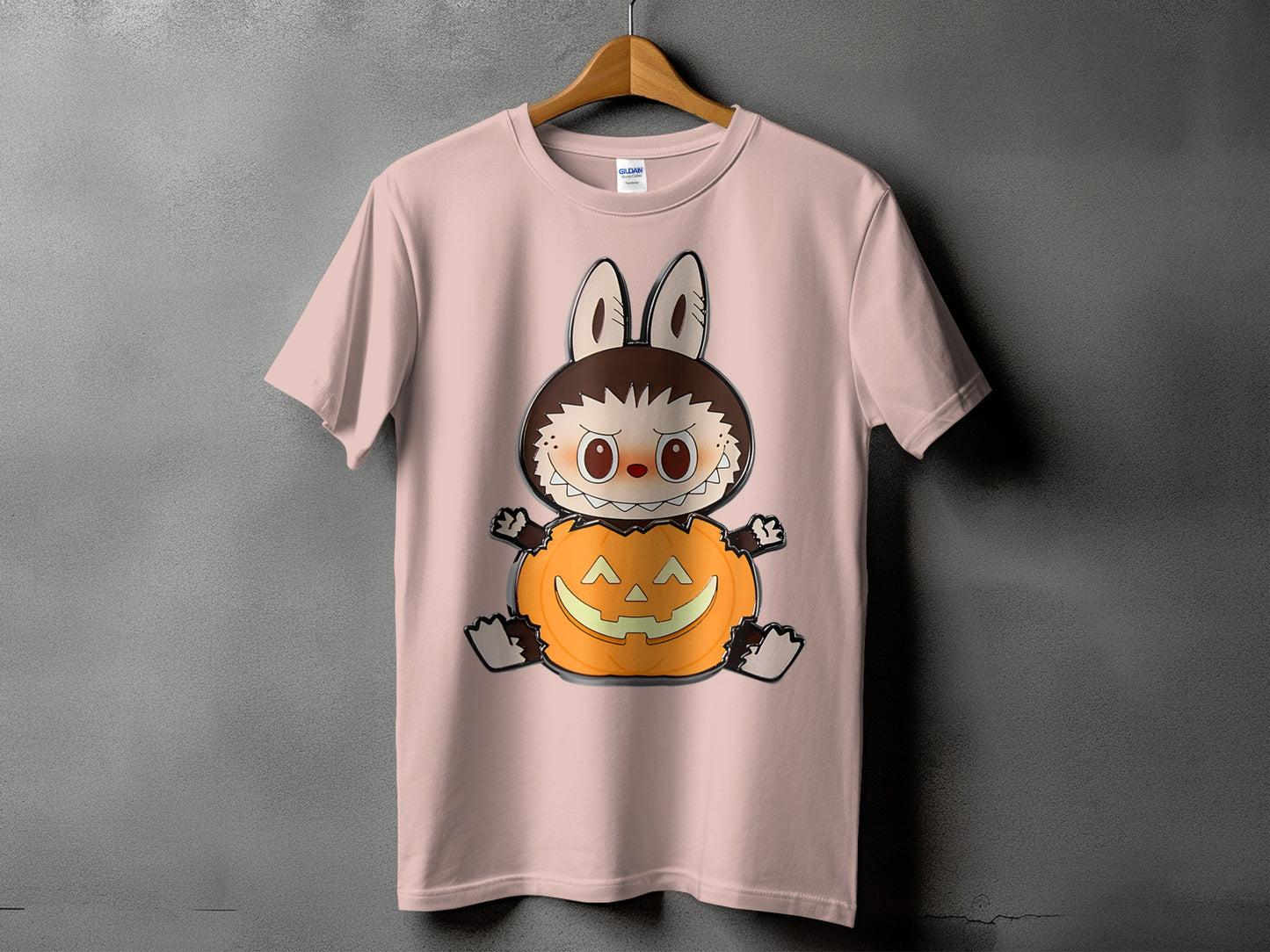 Pink t-shirt with a cartoon character sitting in a carved pumpkin.