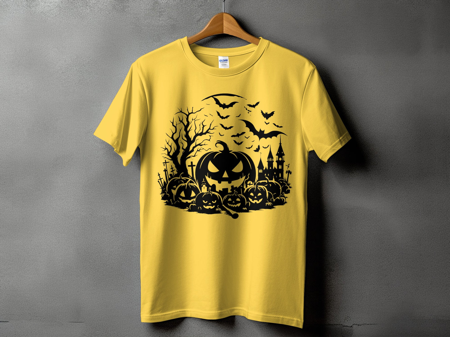 Yellow t-shirt with a black Halloween graphic featuring pumpkins, bats, and a haunted house.