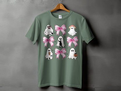 Green t-shirt with a graphic of ghosts, bows, a black cat, and Halloween icons.