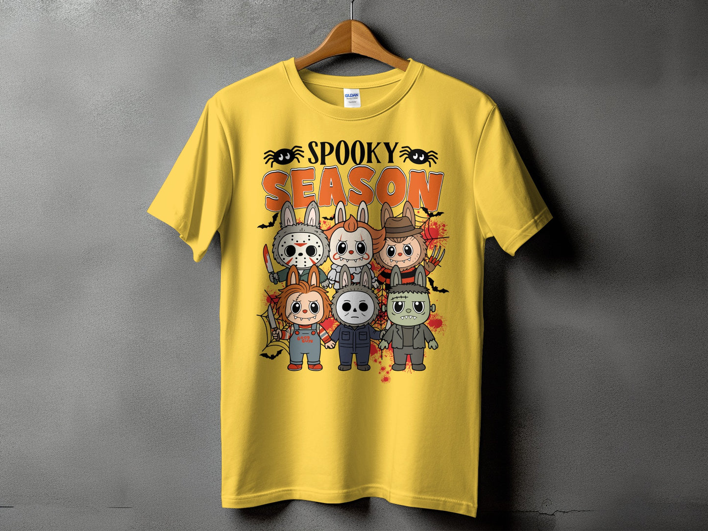 Yellow t-shirt with "Spooky Season" text and cartoon horror characters in bunny costumes.