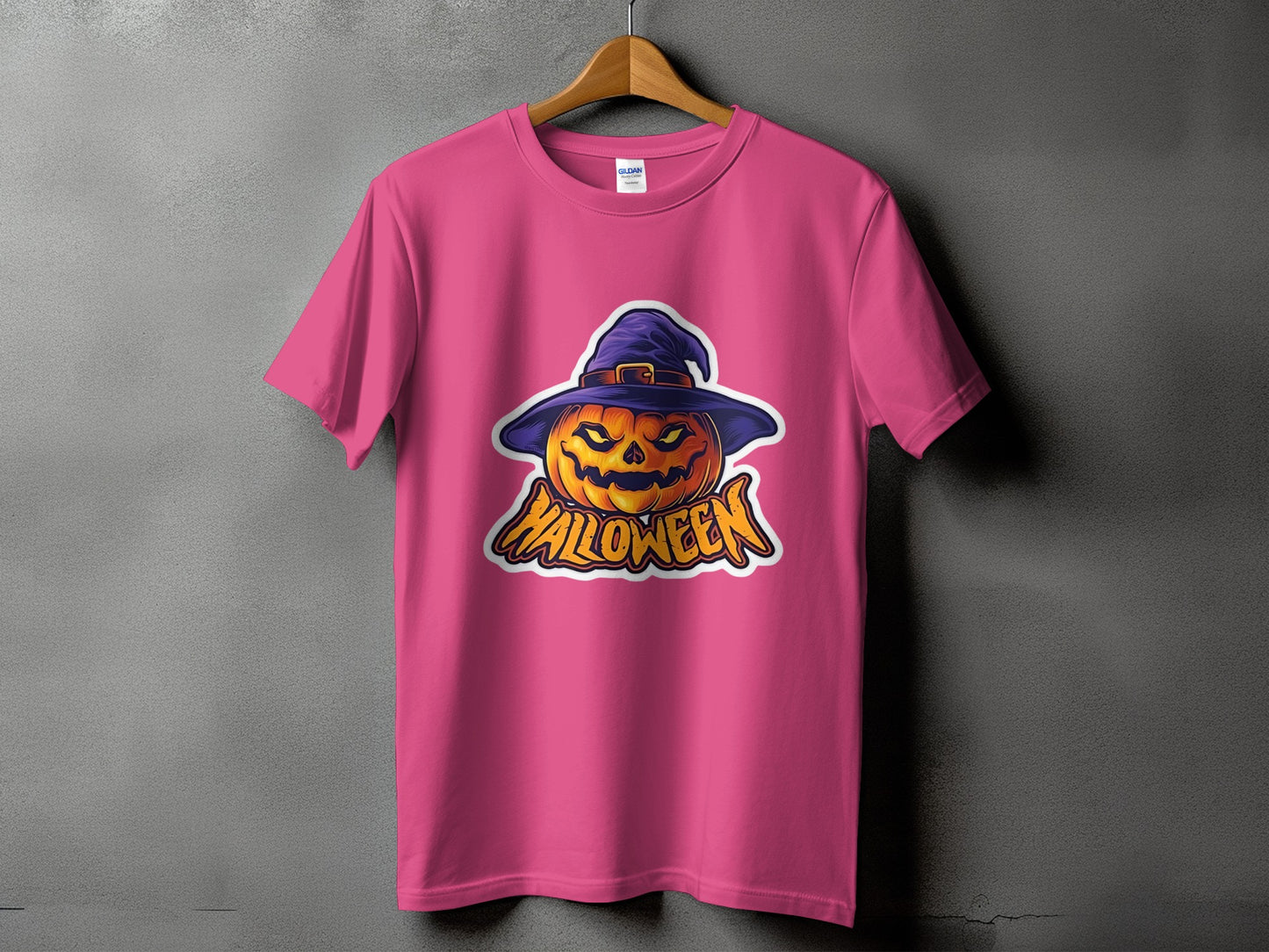 Pink t-shirt with a graphic of a jack-o'-lantern wearing a witch hat and the word "Halloween".