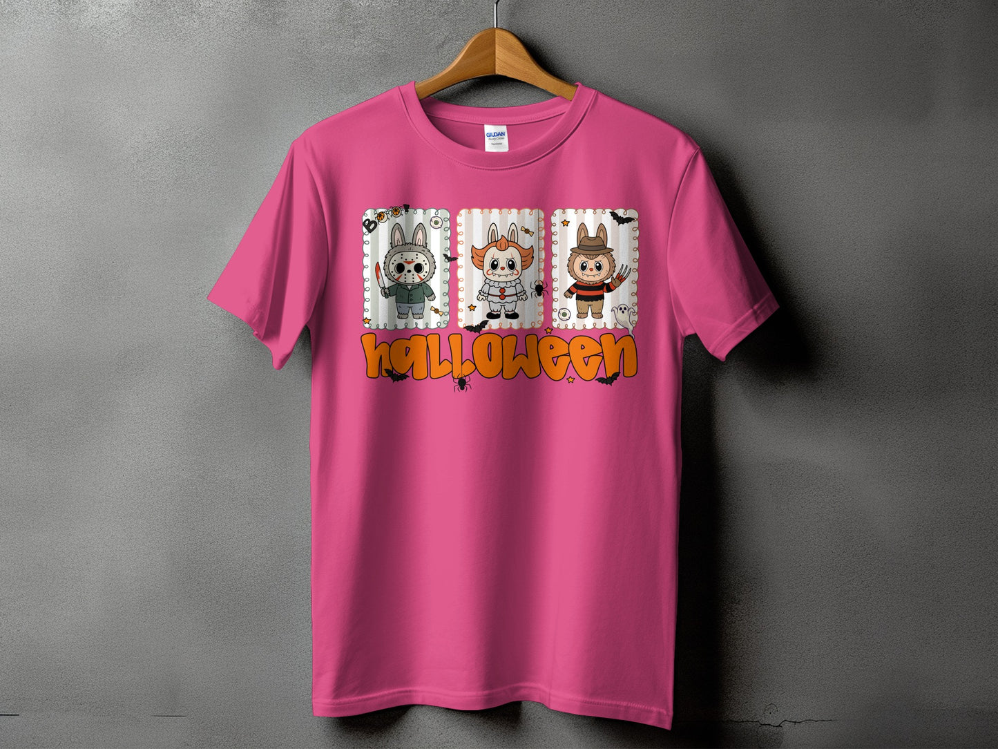 Pink t-shirt with Halloween graphic featuring three cartoon characters and text.