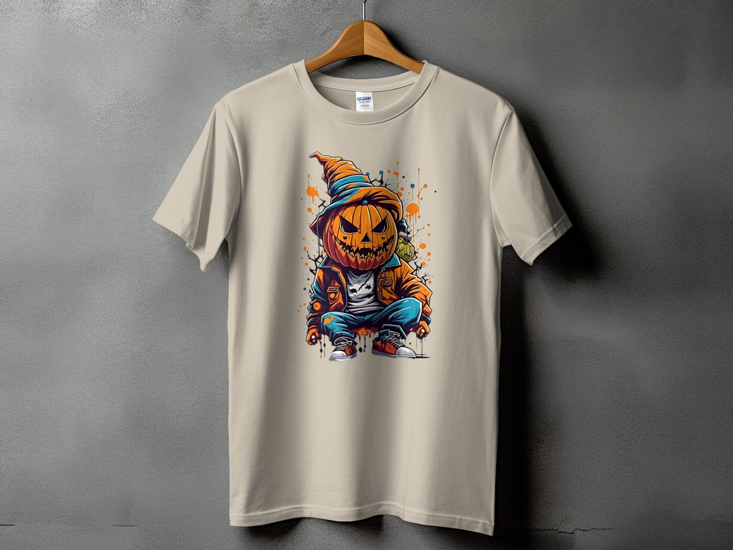 Tan t-shirt featuring a cartoon pumpkin character with a witch hat.