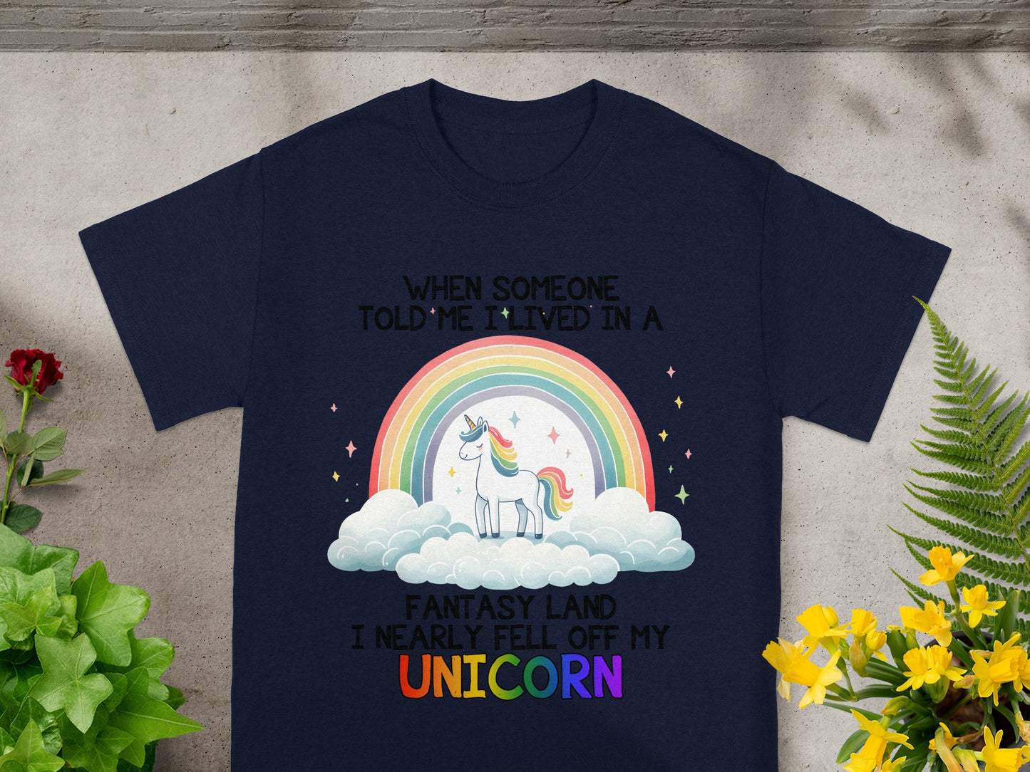 Navy t-shirt with a graphic of a unicorn, rainbow, and text.
