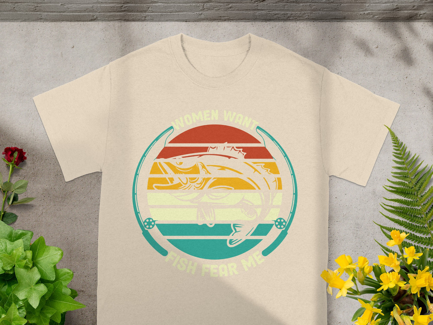 Graphic on a cream t-shirt with fish, fishing rods, and text "Women want fish fear me."