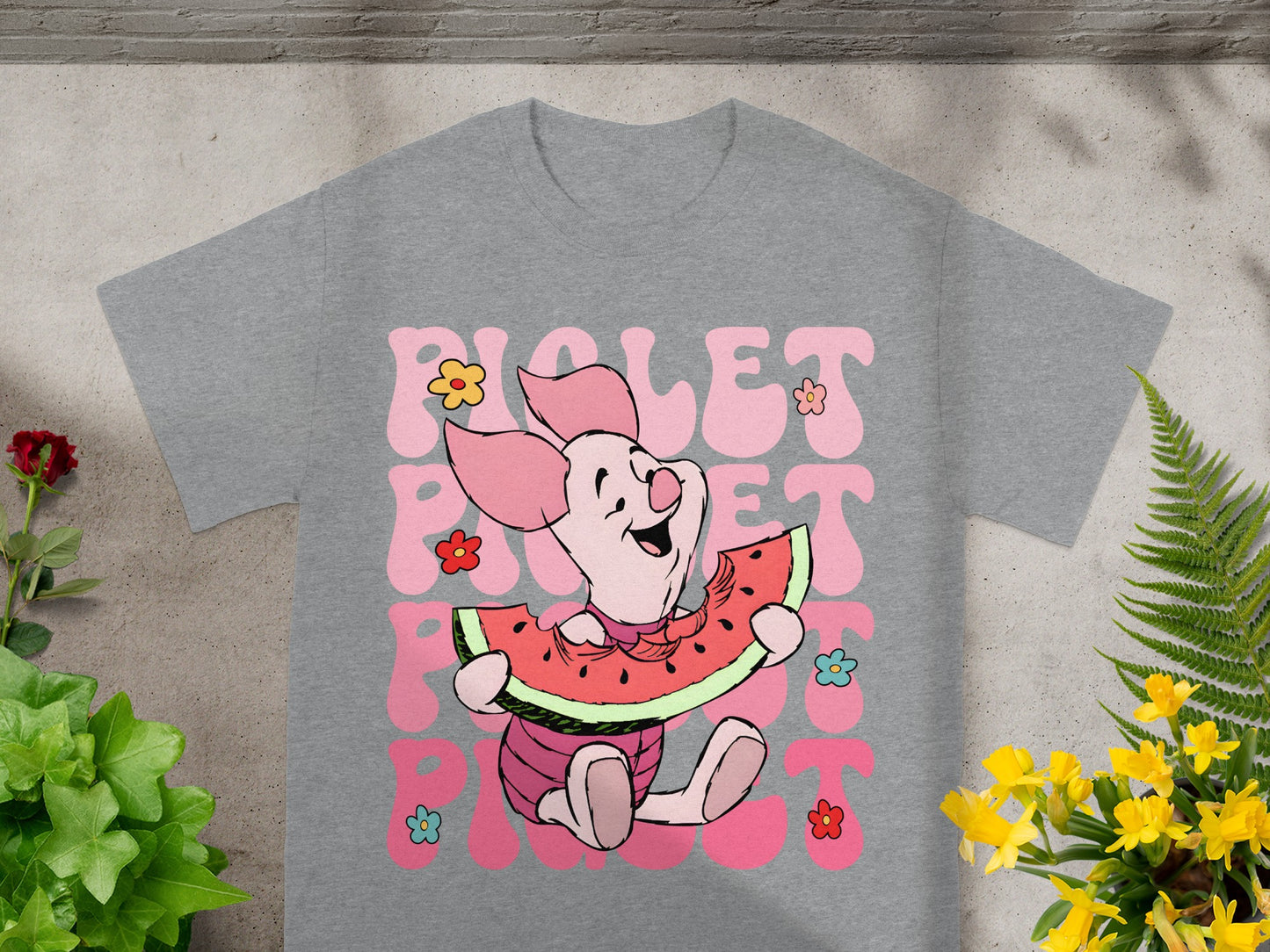 Piglet wearing a pink outfit eating a slice of watermelon, with flowers.