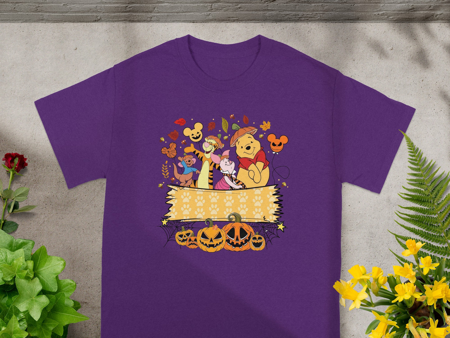 Winnie the Pooh characters in Halloween costumes with pumpkins and autumn leaves.