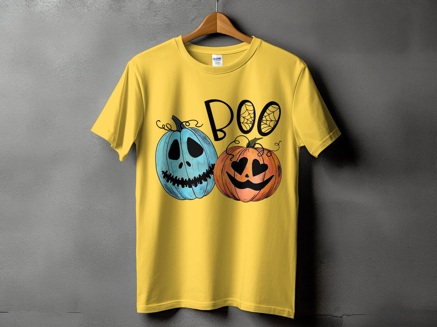 Yellow t-shirt with blue and orange pumpkins and the word "BOO".