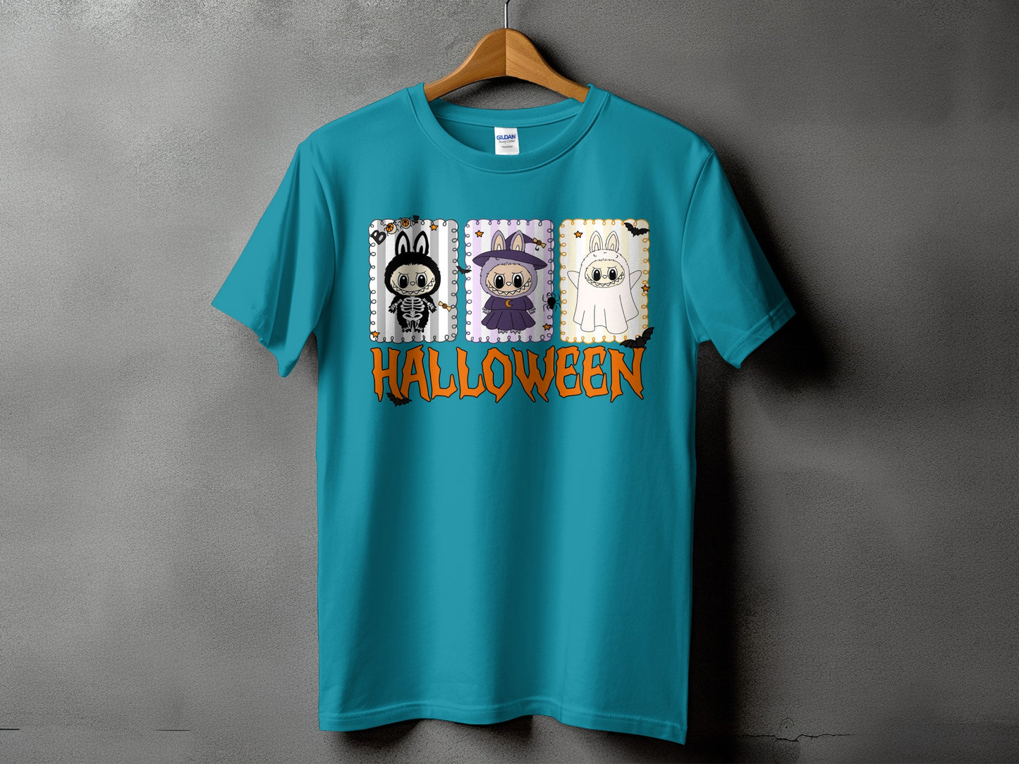 Teal t-shirt with three cute Halloween characters and the word "HALLOWEEN" in orange.