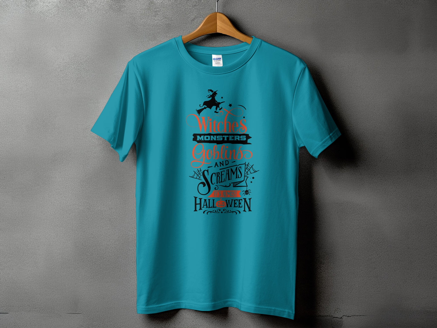 Teal t-shirt with "Witches' Monsters Goblins and Screams It's Almost Halloween" text.