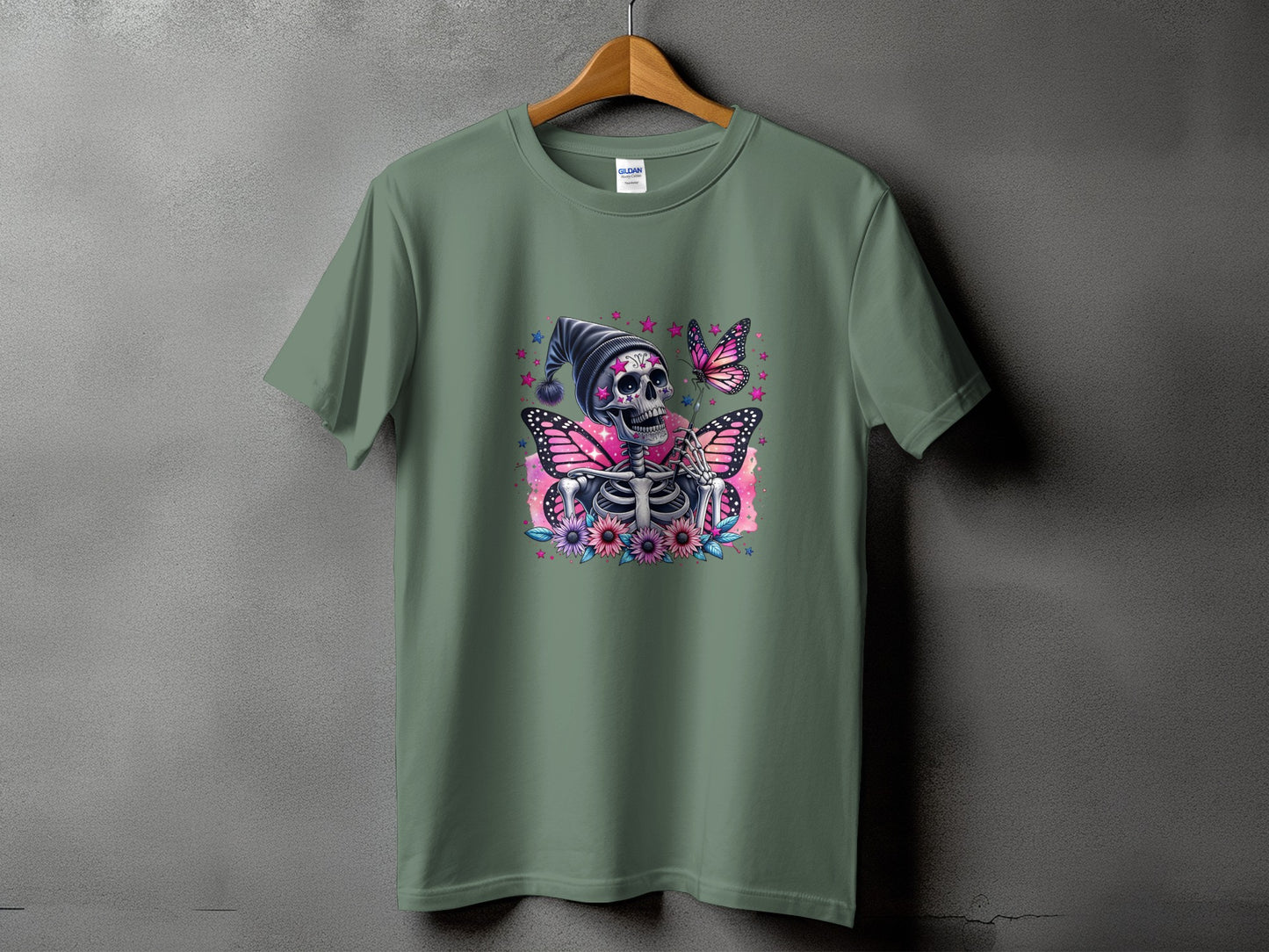 Green t-shirt with skeleton, pink butterflies, and flowers graphic.