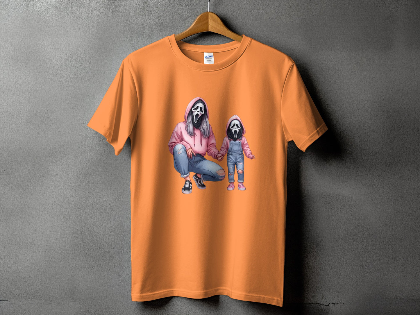 Orange t-shirt with print of ghost mask figures of a woman and child.