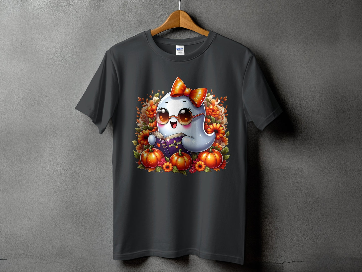 Dark t-shirt featuring a kawaii ghost with a bow and glasses reading a book.