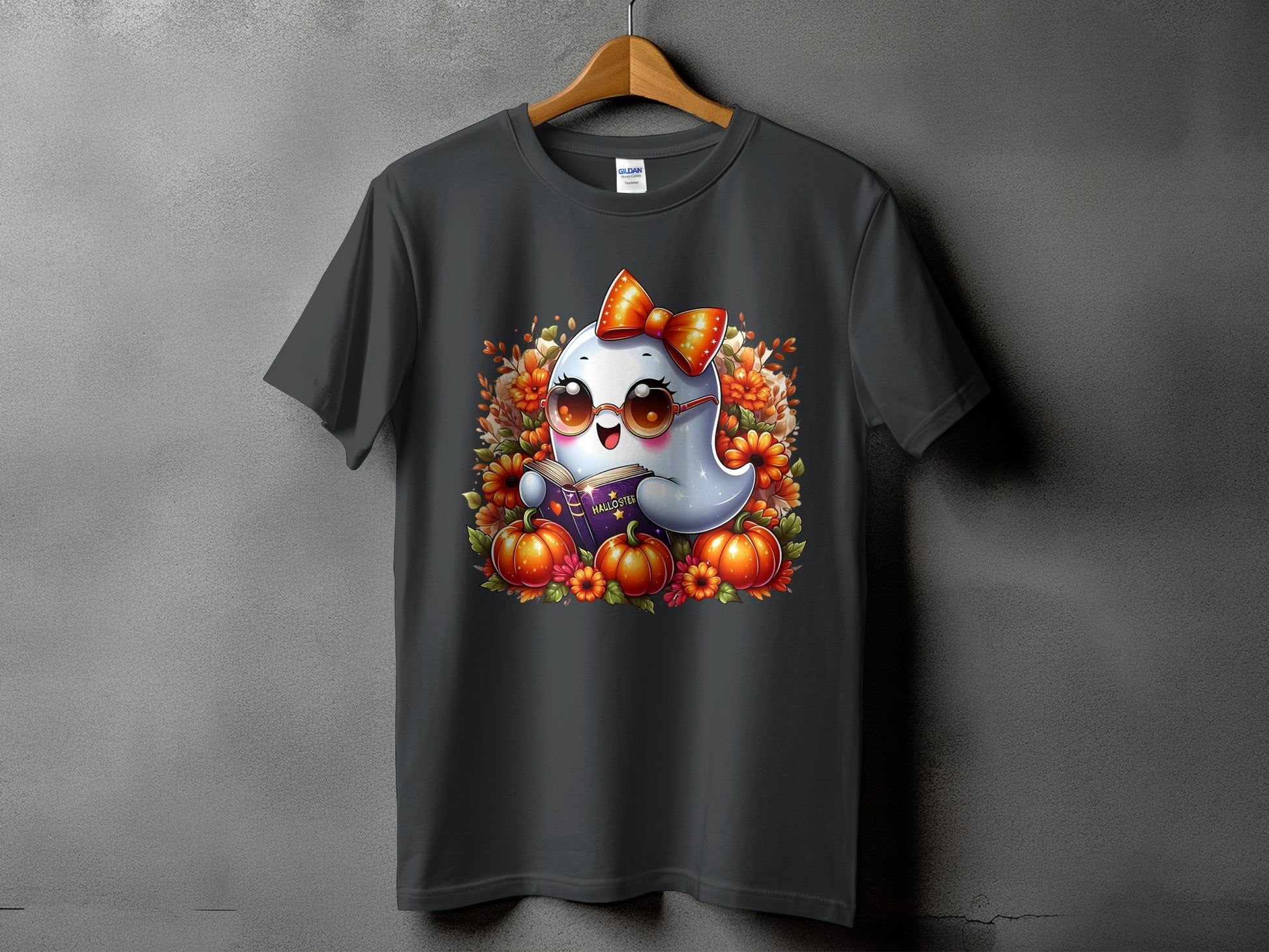 Dark t-shirt featuring a kawaii ghost with a bow and glasses reading a book.