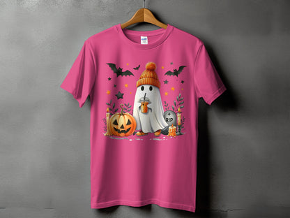 Ghost with beanie holding coffee, pumpkin, bats, candles, and RIP tombstone on pink t-shirt.