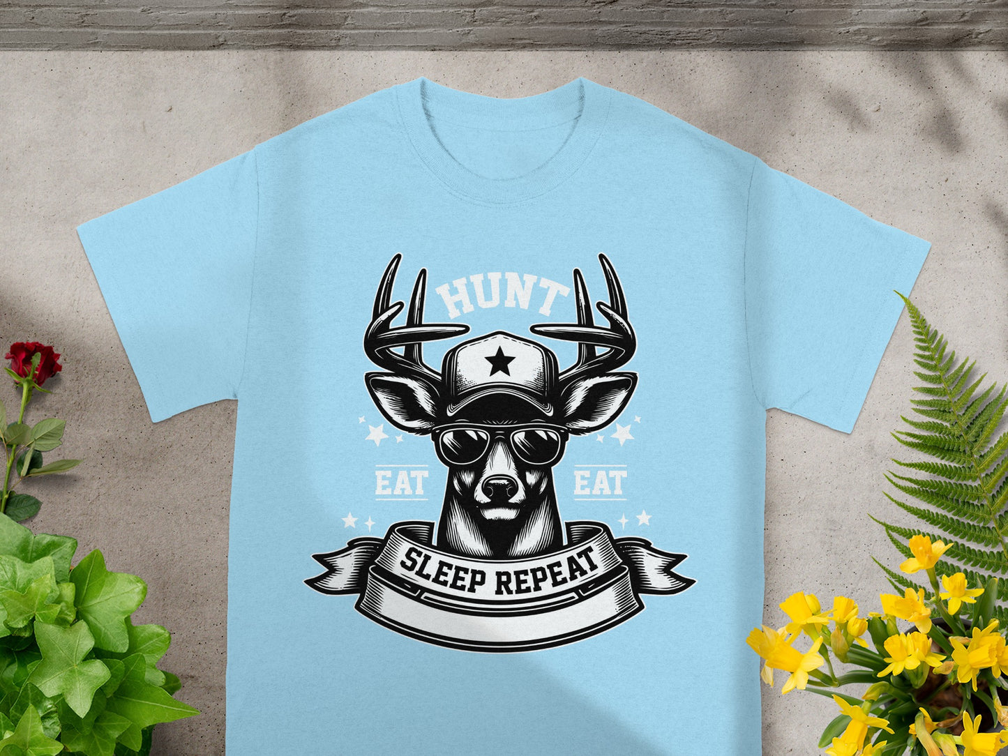 Light blue t-shirt with a graphic of a deer wearing a hat and sunglasses, with text.