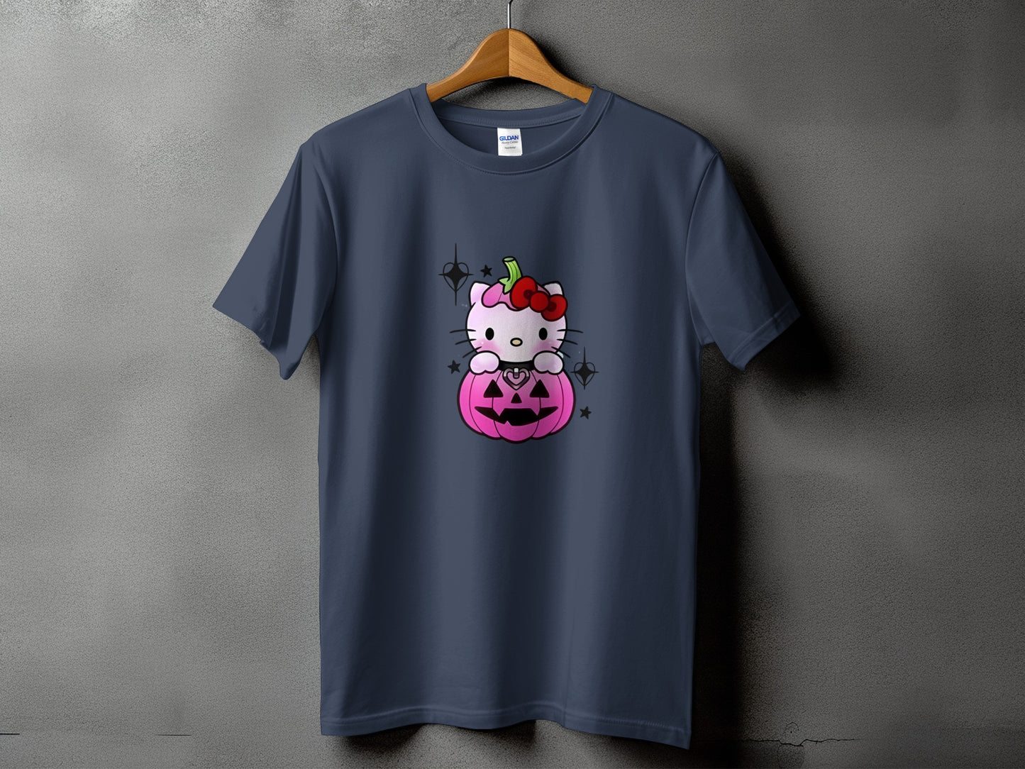 Dark blue t-shirt with Hello Kitty sitting in a pink jack-o'-lantern.