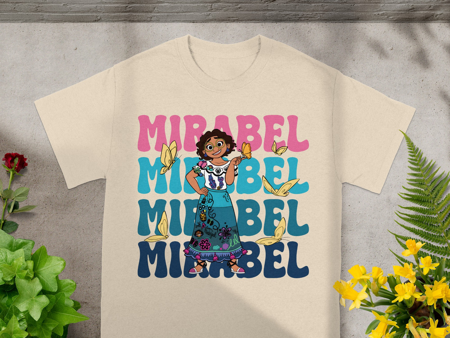 Mirabel from Encanto with butterflies, text reads "MIRABEL" in large letters.