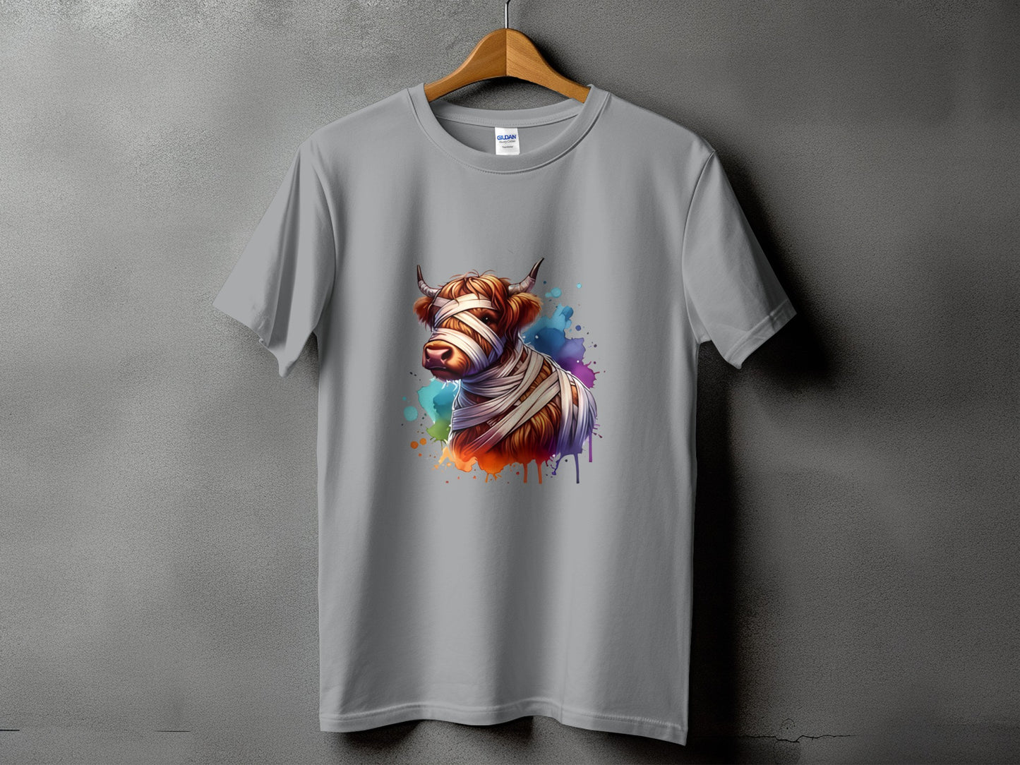 Grey t-shirt with a watercolor-style graphic of a cow wrapped in bandages.