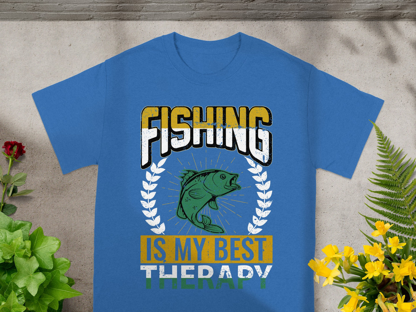 Blue t-shirt with text "FISHING IS MY BEST THERAPY" and a fish graphic.