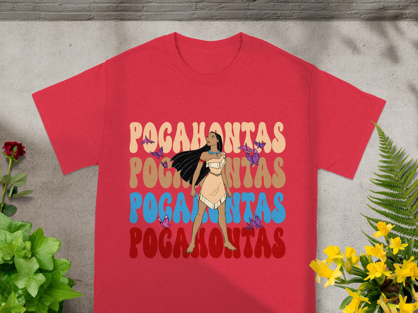 Red t-shirt with "Pocahontas" in colorful, layered text and floral accents.