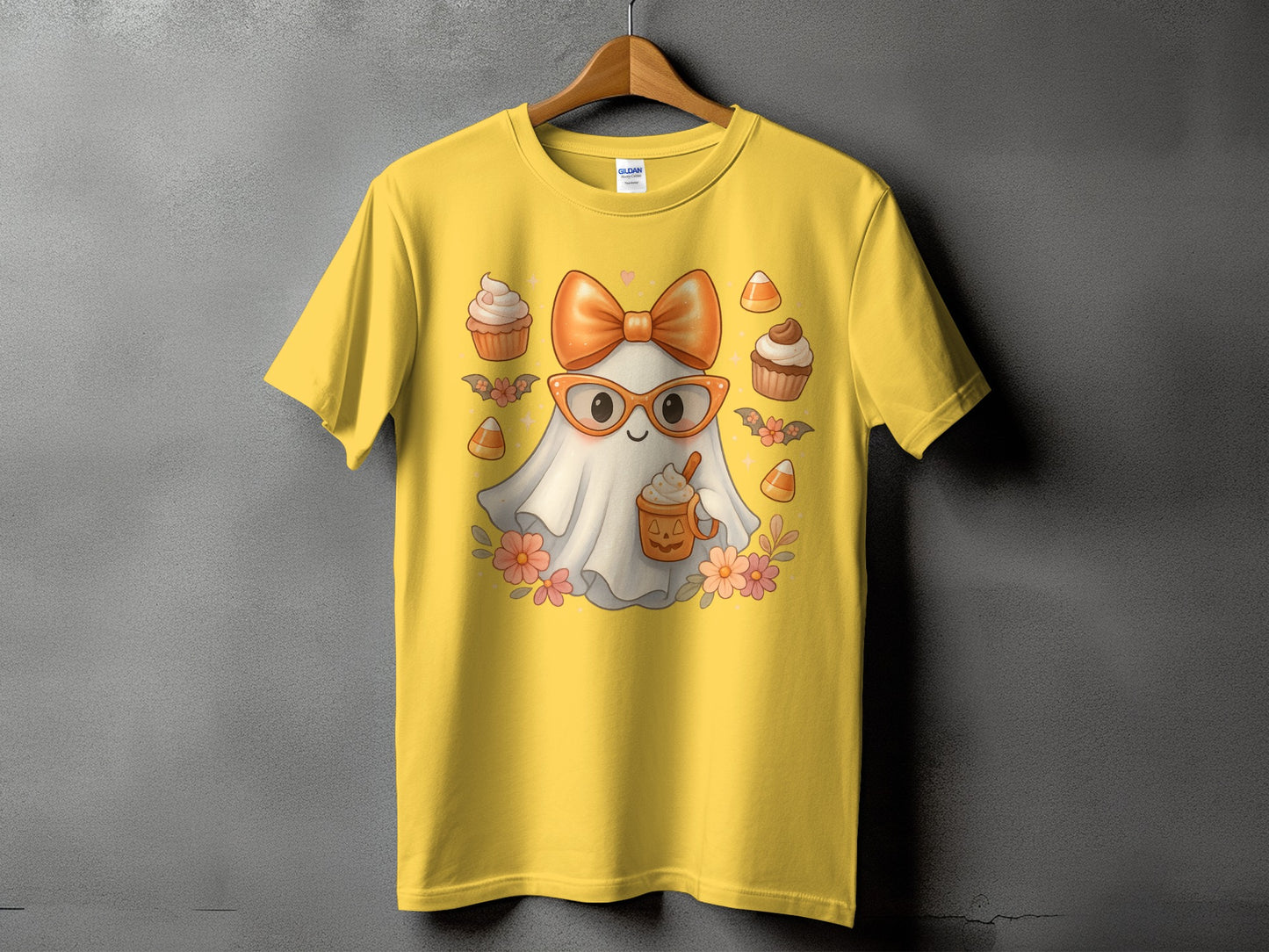 Yellow t-shirt with ghost graphic holding a pumpkin spice latte.