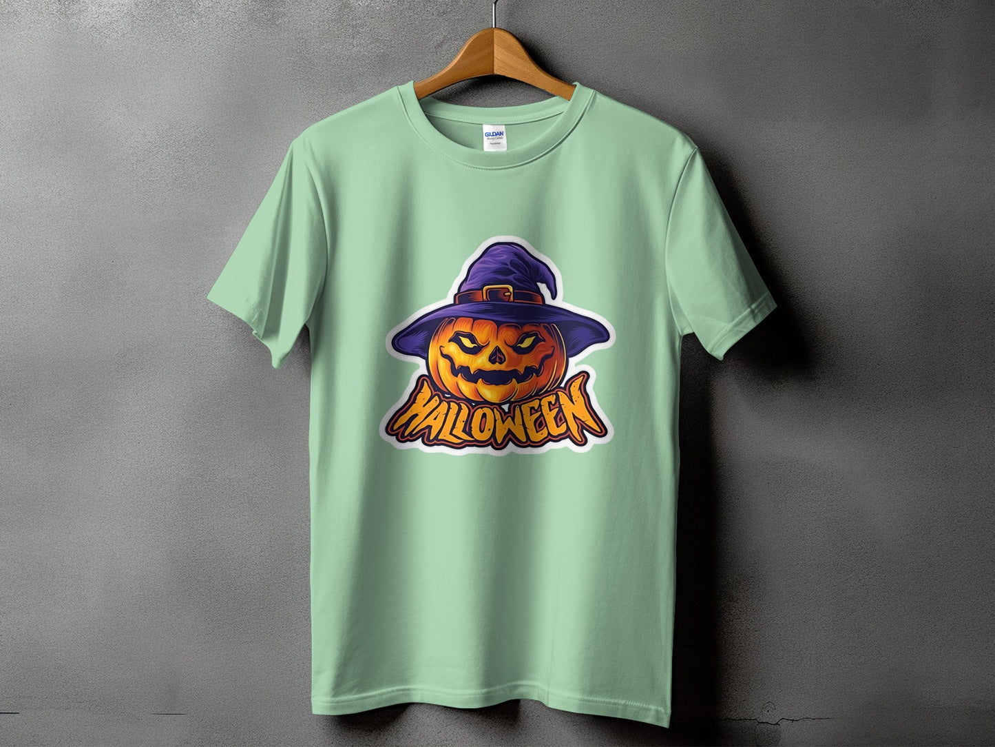 Light mint green t-shirt with a spooky jack-o'-lantern wearing a witch hat and the word "Halloween".