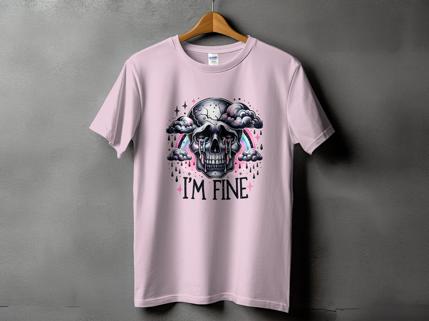 Pink t-shirt with a crying skull, rainbow, and "I'M FINE" text.