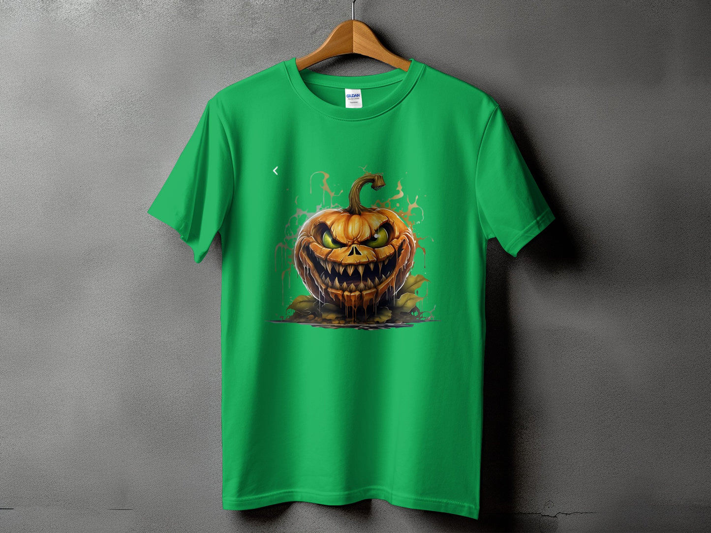 Green t-shirt with a scary jack-o'-lantern graphic and orange splashes.