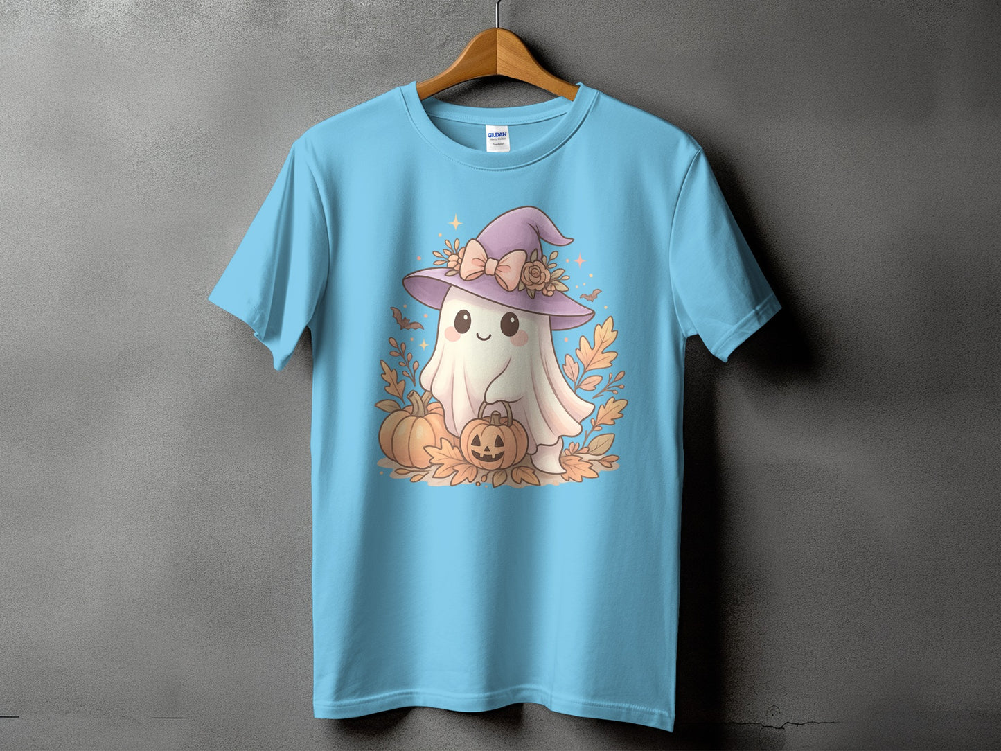 Light blue t-shirt with a cute ghost wearing a witch hat and holding pumpkins.