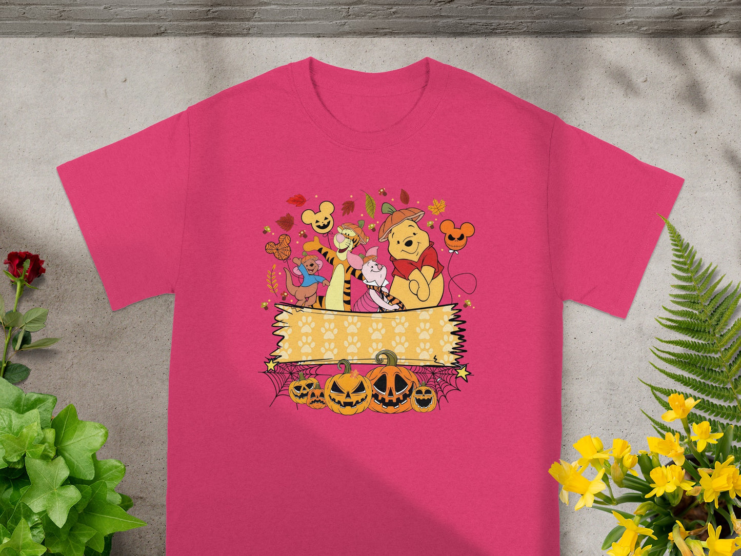 Winnie the Pooh characters in Halloween costumes with pumpkins and paw prints.