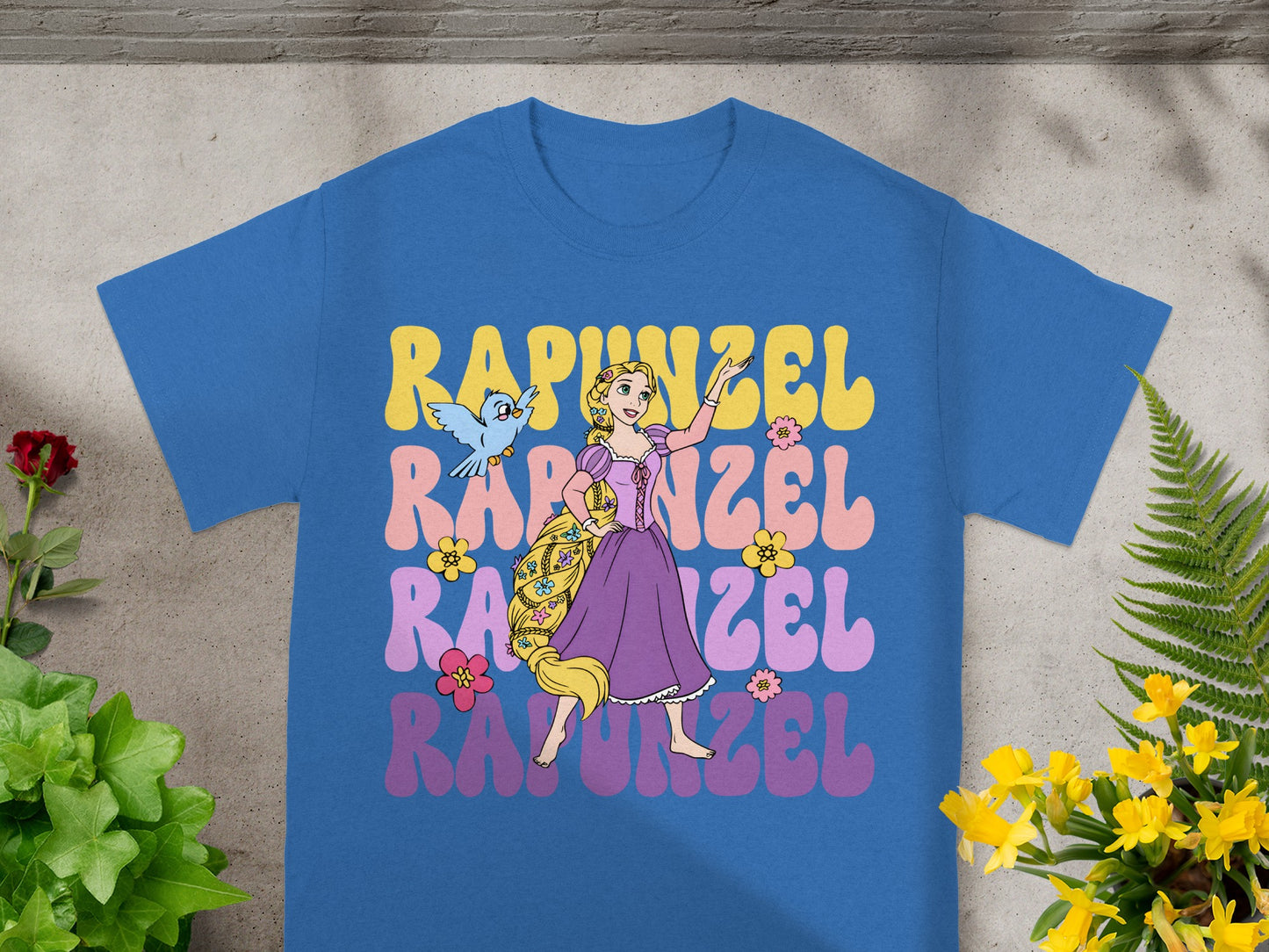 Rapunzel in retro font with Pascal and a bird on a blue t-shirt.