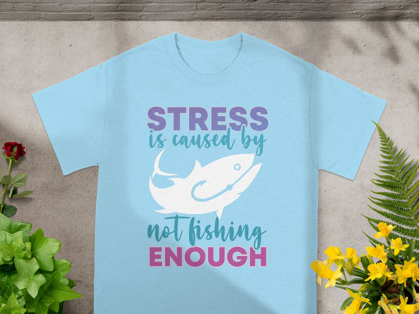 Light blue t-shirt with text "STRESS is caused by not fishing ENOUGH" and fish graphic.