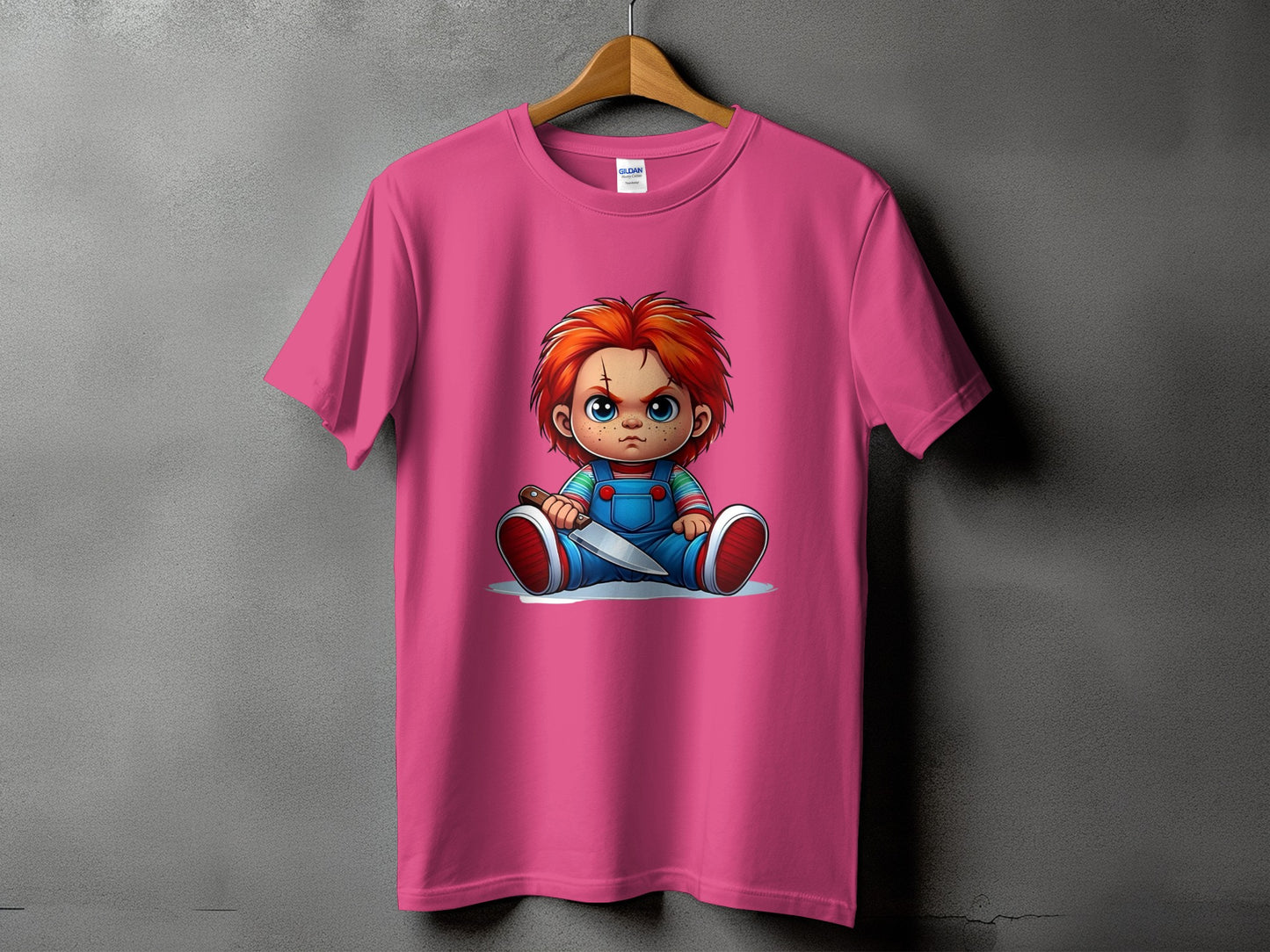 Pink t-shirt featuring a cartoon of Chucky holding a knife.