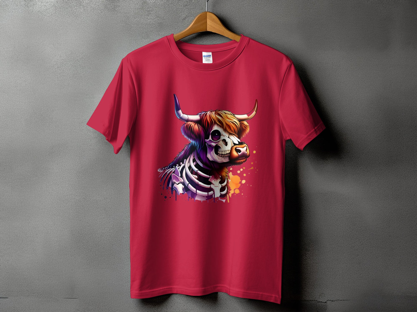 Crimson t-shirt with a skeleton Highland cow graphic and colorful splatter details.
