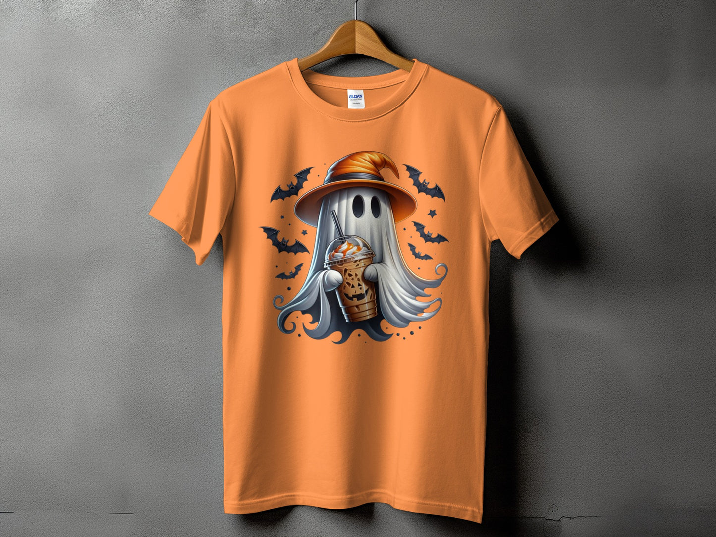 Orange t-shirt with ghost wearing witch hat holding coffee and bats.