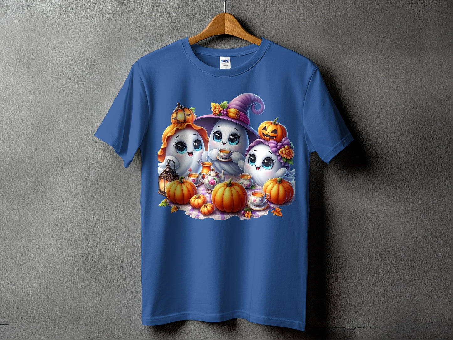 Three cute ghosts with pumpkins and tea set on a plaid blanket.