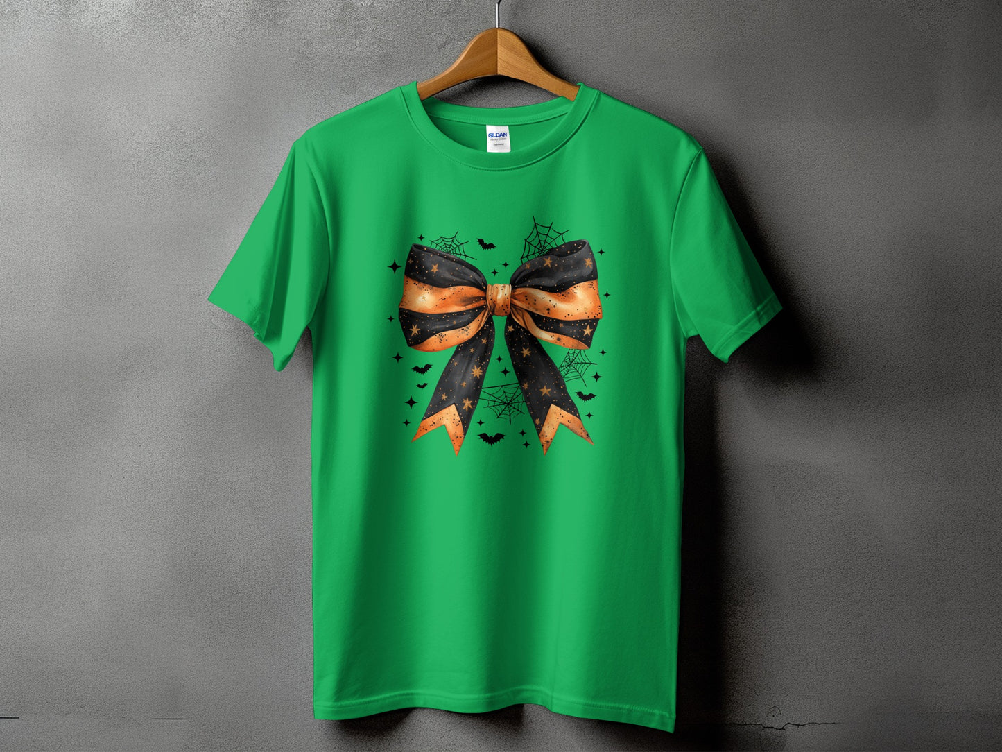 Green t-shirt with Halloween-themed orange and black bow graphic.