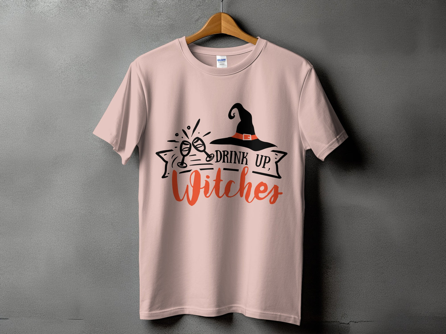 Pink t-shirt with "Drink Up, Witches" graphic and a witch hat.