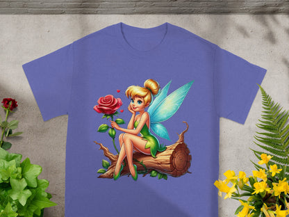 Fairy with wings and green dress sits on a log with a rose.