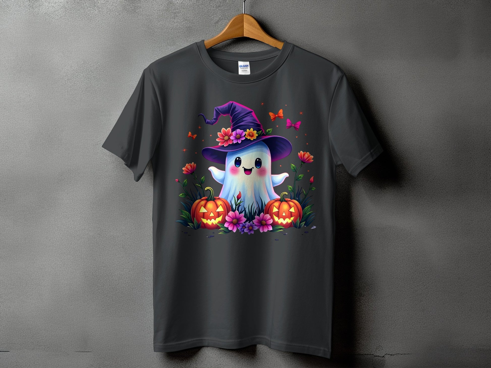 Dark grey t-shirt with a cute ghost wearing a witch hat and surrounded by pumpkins and flowers.
