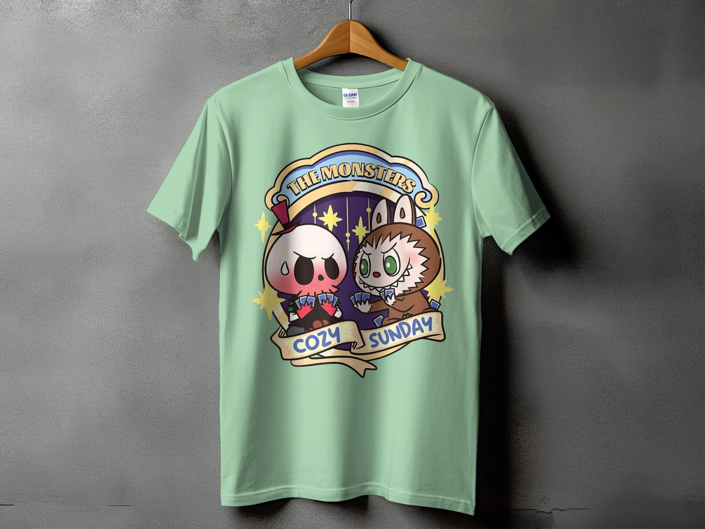 Green t-shirt with "The Monsters Cozy Sunday" graphic featuring cartoon skull and werewolf characters.