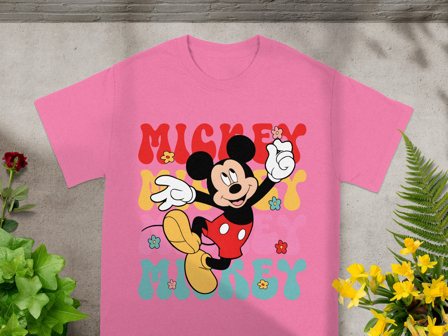 Pink t-shirt with Mickey Mouse and "MICKEY" text in colorful, retro font.