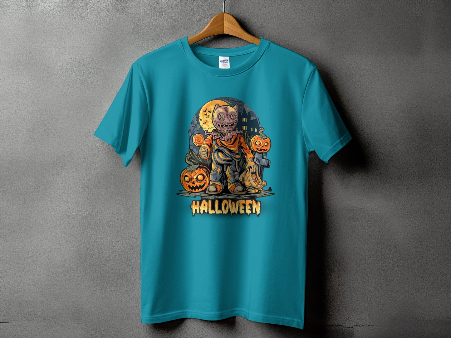 Teal t-shirt with a Halloween graphic featuring a pumpkin monster and pumpkins.