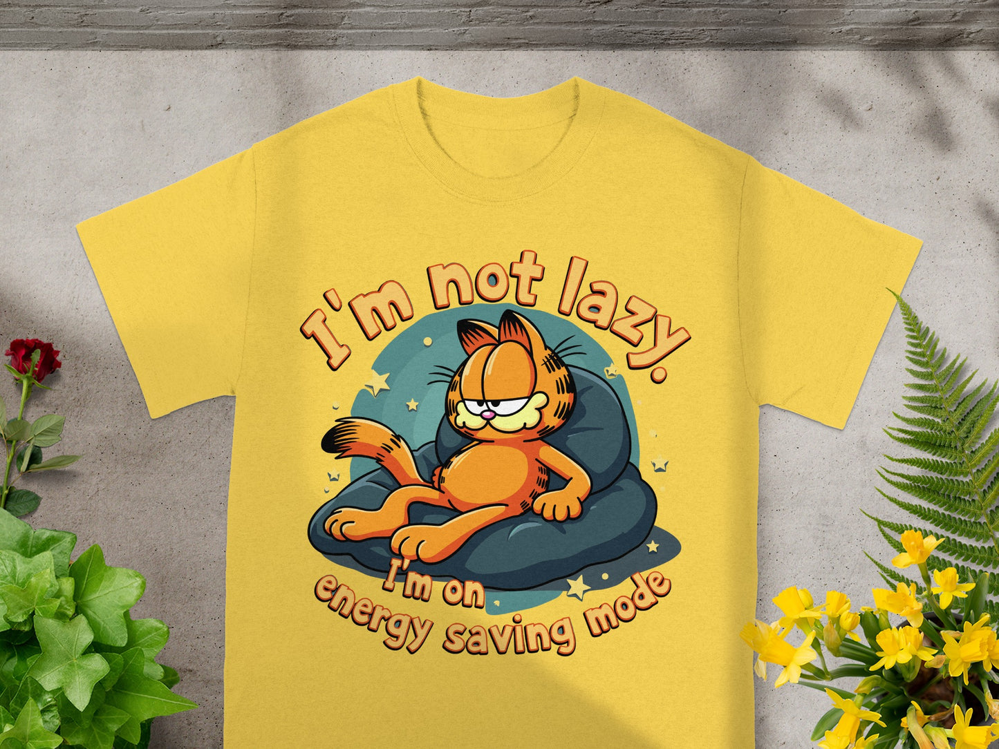 Yellow t-shirt with Garfield lying on a cushion, text reads "I'm not lazy. I'm on energy saving mode."