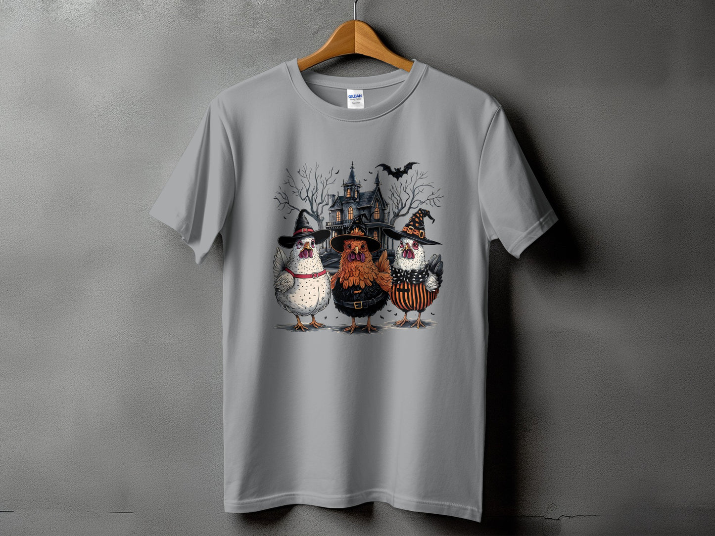 Three chickens in Halloween costumes stand before a spooky house and bare trees.