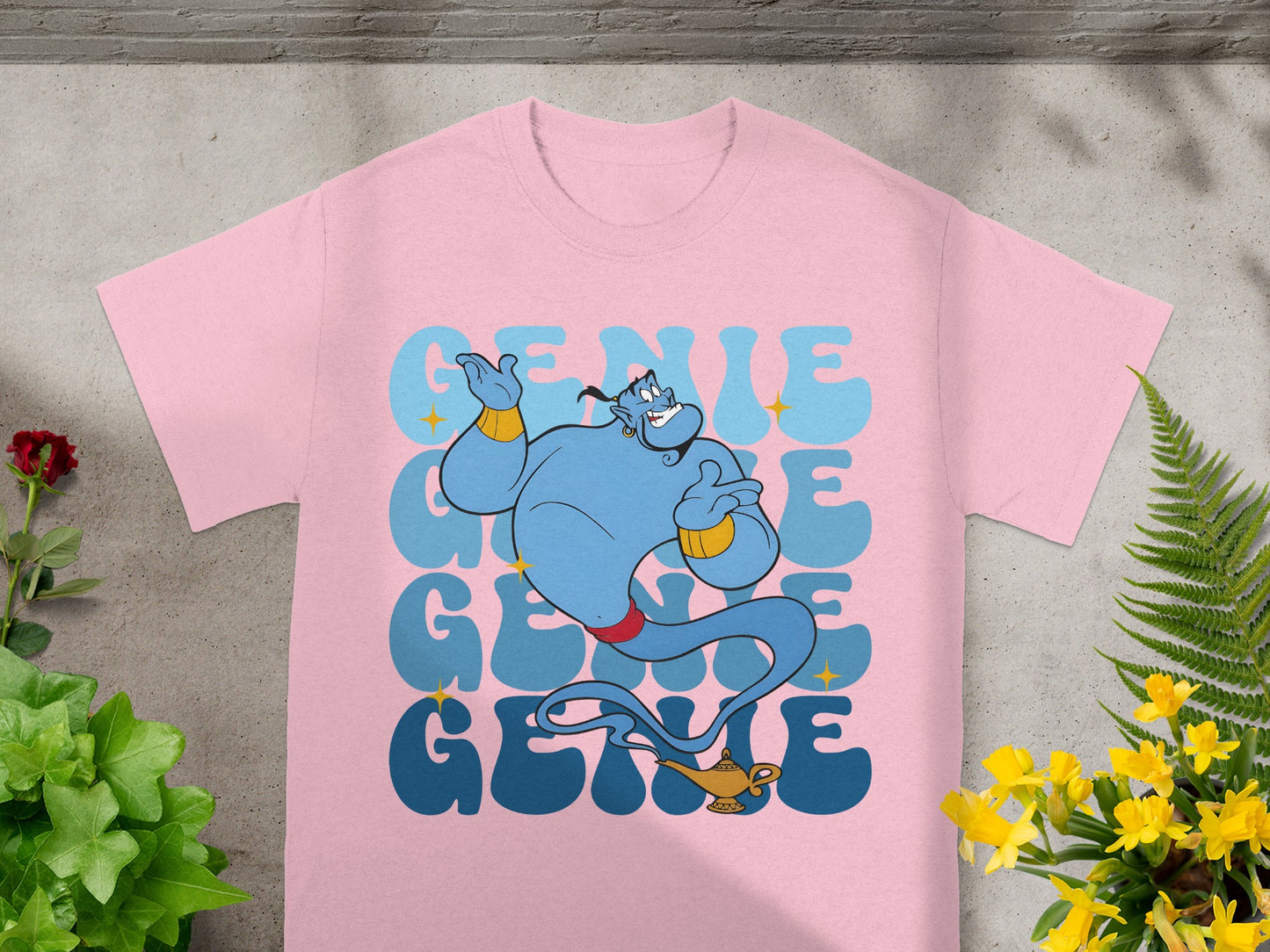 Pink t-shirt with blue genie graphic and "GENIE" text.