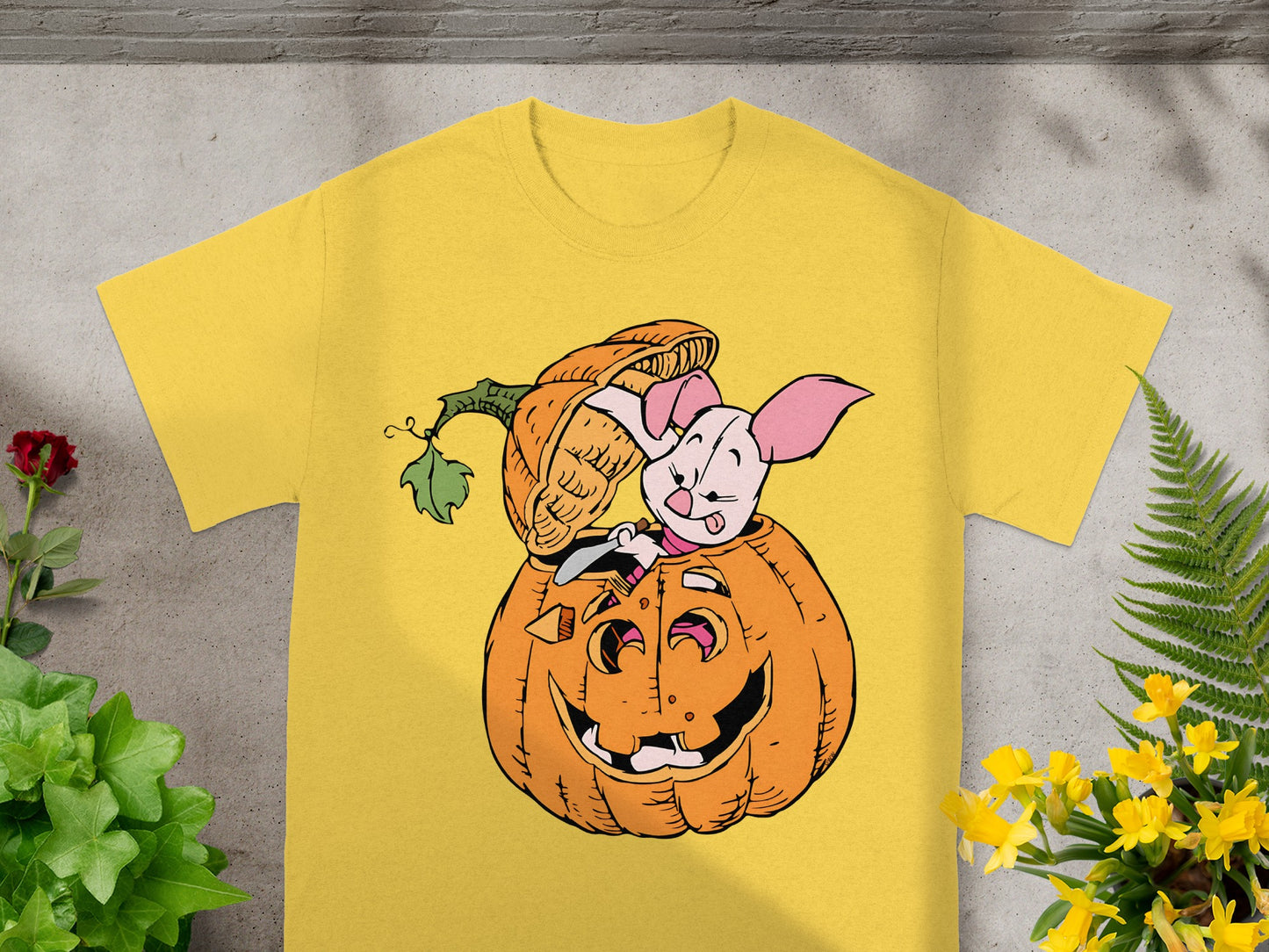 Yellow t-shirt with Piglet peeking out of a jack-o'-lantern.